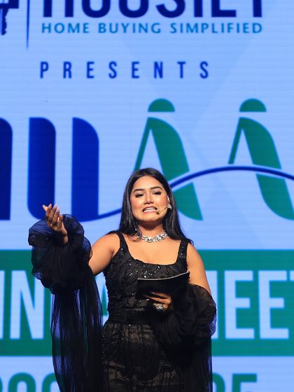 On stage for the Housiey Annual Meet. My expressive style helps convey the excitement and importance of the awards being presented.