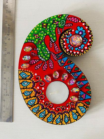 Another one of my paisley candle holders, this one in a fiery red with intricate blue and yellow details. Each one is painted differently, so you get a truly unique piece.