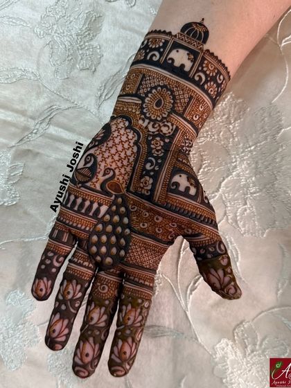 A close-up of one hand, showing the fine details and the combination of bold and delicate patterns.