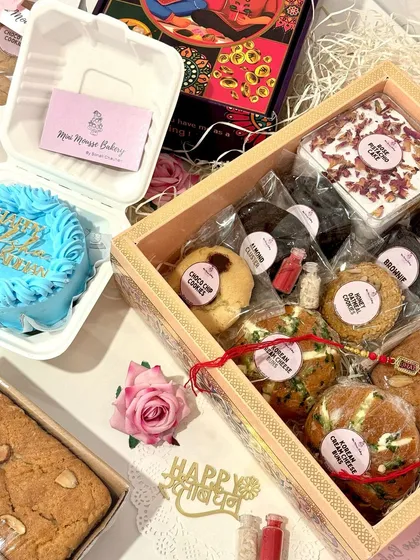 A complete Rakhi celebration in a box. This view shows how you can combine a larger hamper with a custom bento cake for an extra special touch. I love creating these personalized combinations for your celebrations.