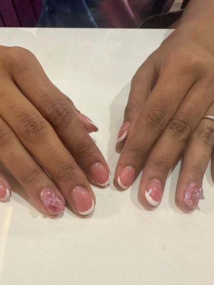 A delicate and cute design featuring a classic French manicure with a tiny 3D butterfly on the accent nail.