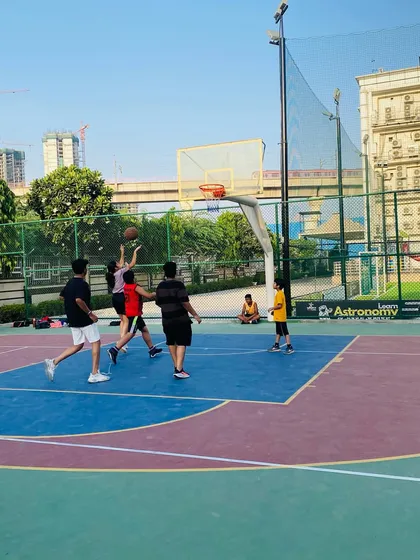 A contested layup attempt during a competitive evening game.