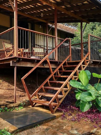 The wooden staircase leading to the cottage's deck, designed to be both functional and elegant.