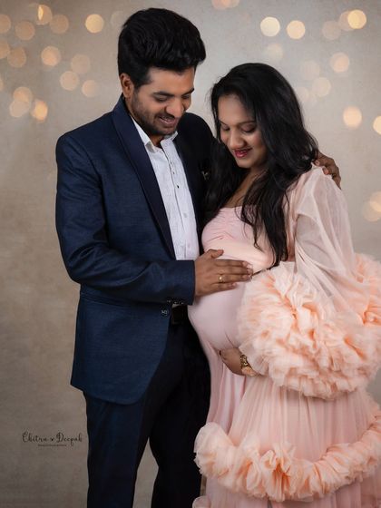A moment of shared joy and anticipation. The soft lighting and genuine smiles make this an incredibly warm and heartfelt portrait.