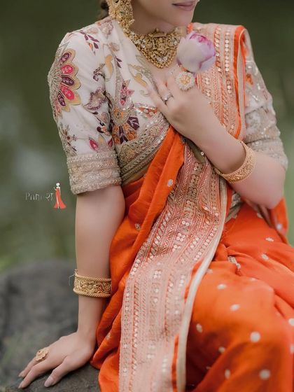 A closer look at the exquisite hand-embroidered blouse paired with our vibrant orange Navwari saree. The floral motifs and delicate detailing highlight the craftsmanship that goes into every piece I create.