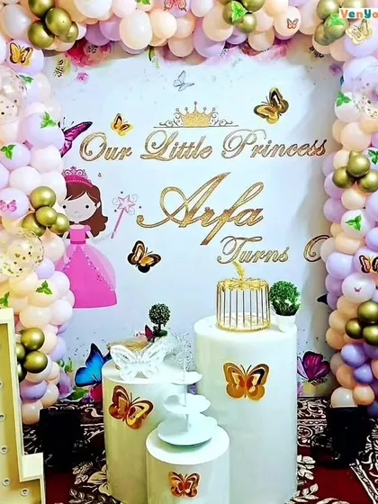 A "Little Princess" birthday theme with butterfly accents. The backdrop includes pastel balloons, gold butterflies, and a custom sign with the birthday girl's name.