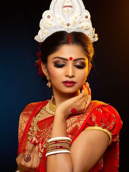 Capturing the essence of a Bengali bride. This look is defined by the traditional 'mukut', bold eyes, and the red bindi, all styled and photographed in our studio.