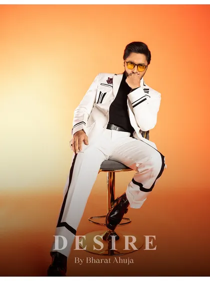 Another seated pose, this time with a thoughtful expression. The suit is versatile enough for both playful and serious moments.