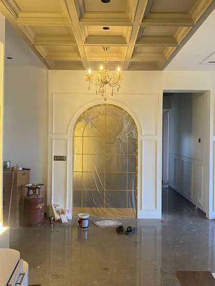 Nearing completion: The walls are painted, the coffered ceiling is finished, and the chandelier is installed. The space is ready for its final furnishings.