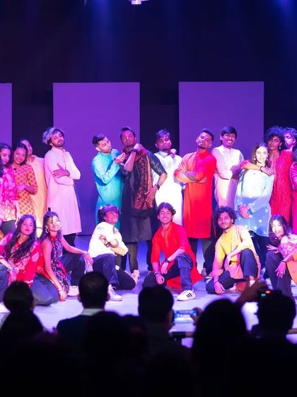 The entire cast of a student showcase on stage. This represents the community we build, a group of dedicated dancers celebrating their collective hard work and passion.