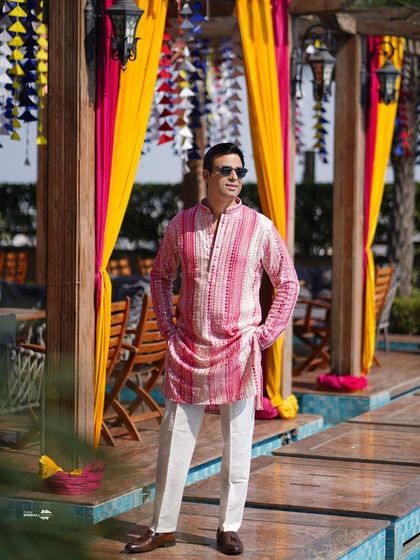 A stylish portrait of the groom at the Haldi ceremony. His cool demeanor and colorful kurta make for a great solo shot.
