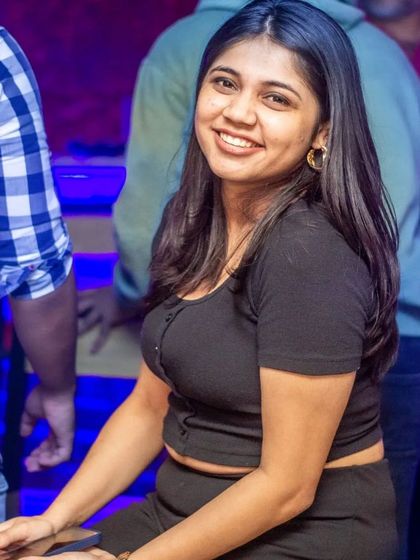 A guest smiling, enjoying the vibrant atmosphere.