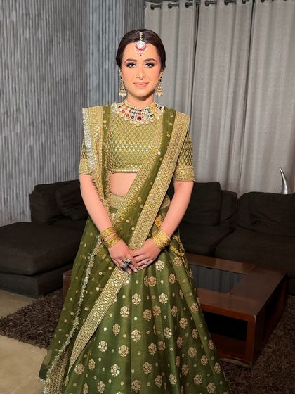 A full view of the Sabyasachi bride, her hair styled in a traditional braid with regal jewelry, embodying timeless grace.