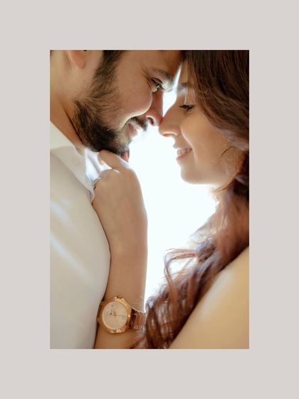 A bright, sun-kissed portrait of the couple. Their smiles and the way they touch foreheads create a feeling of pure happiness and connection.