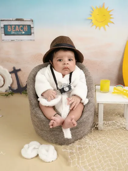 Beach day in the studio. This little one is ready to relax with his bathrobe, sunglasses, and a cool drink in this fun, imaginative setup.