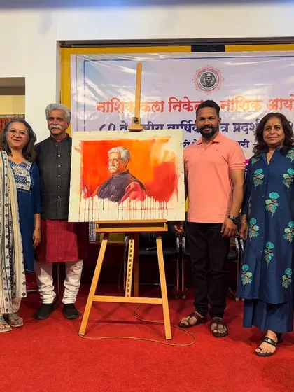 A group of attendees posing with the finished portrait after the demonstration.