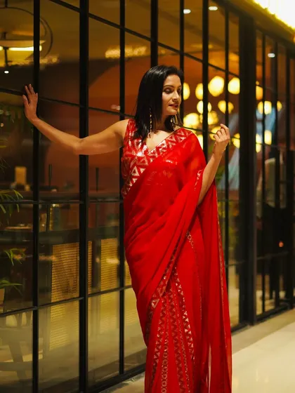 A full-length view of the ravishing red sequin saree. The way it catches the light is just incredible, making it a true showstopper for any glamorous event.