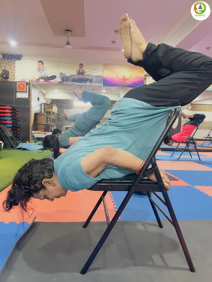 Here you can see the focus and determination in practicing Purna Shalabhasana with a chair. This pose is excellent for building a strong and flexible back.