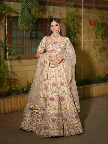 A full-length shot capturing the entire look in a beautiful outdoor setting. The bride looks like a modern princess in her floral lehenga.