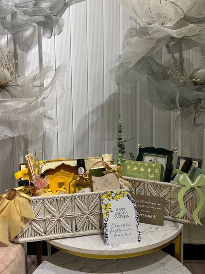 A beautiful green and yellow themed Rakhi hamper. The macrame baskets and personalized card make it a thoughtful and stylish gift.