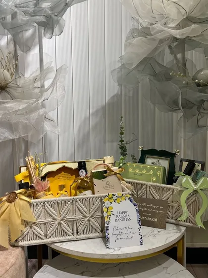 A beautiful green and yellow themed Rakhi hamper. The macrame baskets and personalized card make it a thoughtful and stylish gift.