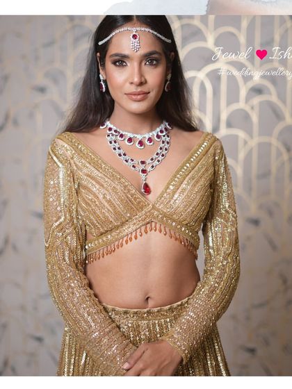 A full view of the ruby and diamond set paired with a shimmering gold lehenga. This look is pure glamour, perfect for a grand sangeet night or a lavish reception party.