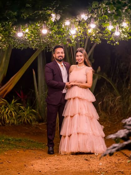The hanging lights in our garden create a beautiful, starry-night effect for this romantic couple's photo.
