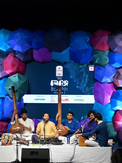 The vibrant stage setup for the 'Barish' concert, with a backdrop of colorful umbrellas. The atmosphere was as lively as the music.