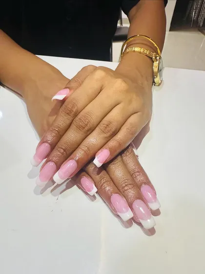 A classic French manicure on longer, square-shaped nails. This is a versatile and timeless look that is perfect for any special occasion.