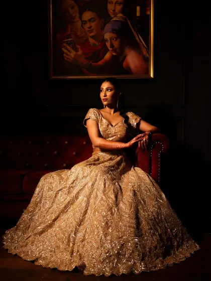 A stunning, editorial-style portrait of the bride at her cocktail party, set against a dark, artistic background.