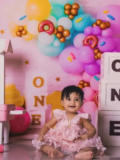 A wide shot of our colorful candy-themed first birthday setup. We can build entire worlds for your child's milestone session.