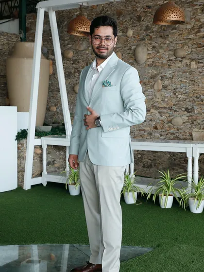 For a sundowner engagement, we crafted this light sage green jacket with cream trousers. The look is elegant and understated, reflecting the groom's personality while being comfortable enough for the dancefloor.