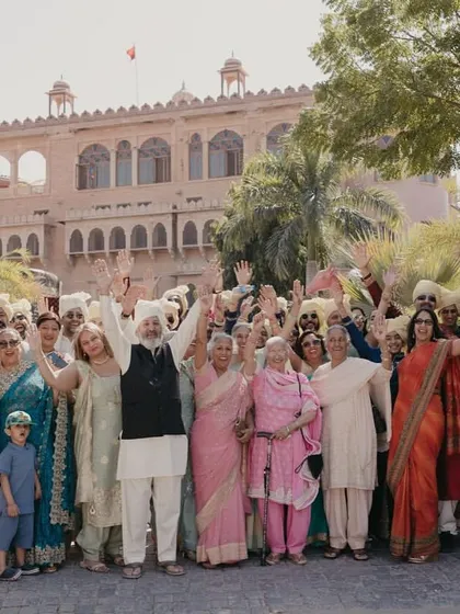 The entire wedding party cheering as the couple makes their way through the fort.