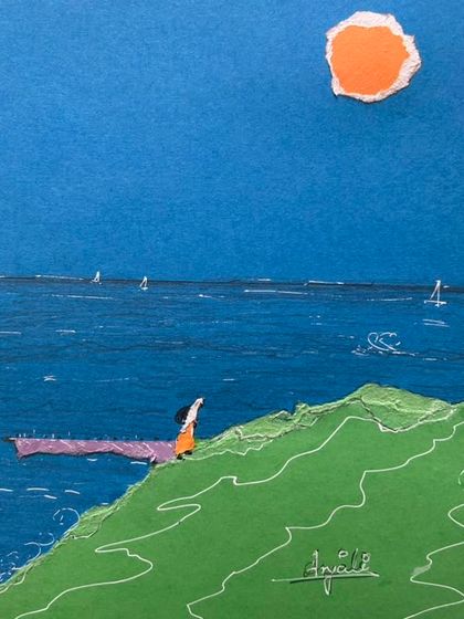 A serene seaside collage made from torn paper. The lone figure looking out at the ocean creates a contemplative mood, capturing a quiet moment of reflection.