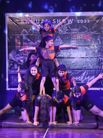 A full-stage view of one of our impressive human pyramids from the 'Tarulya' 2023 showcase. This demonstrates the culmination of months of practice in balance, strength, and trust.