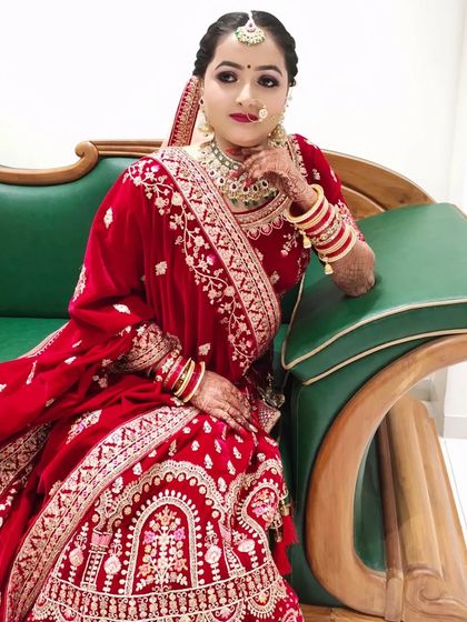 A close-up of the bride, highlighting the soft yet defined makeup. Her skin looks radiant, and the lip color perfectly complements her outfit.