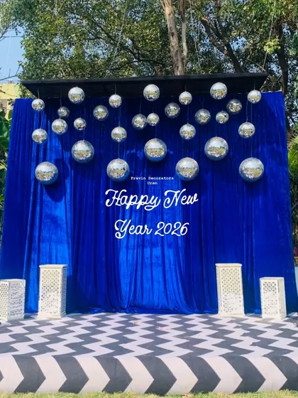 A fun selfie booth is a must for any modern party. For this New Year's event, I created a vibrant photo zone with a royal blue velvet backdrop, a custom sign, and dozens of sparkling disco balls.