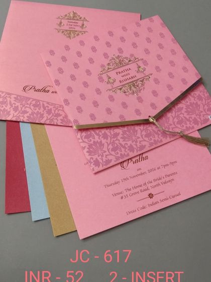 A bright pink invitation with a traditional pattern and a gold tassel. This budget-friendly card includes multiple inserts in various colors for a fun and festive suite.