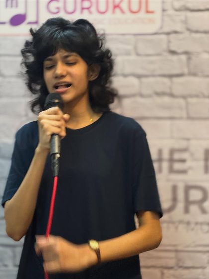 A student completely absorbed in her performance. We teach vocal techniques that allow our singers to express themselves fully and confidently.