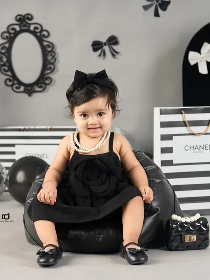 A different pose in the same chic setup, this time on a comfy beanbag. She looks so poised and cute.