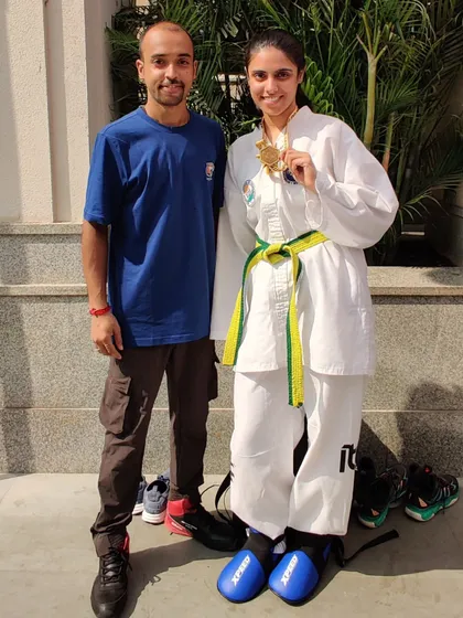 A student with her coach after a successful competition, showcasing the mentor-student bond we cherish.