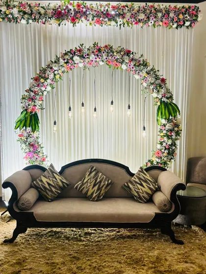 A full view of our popular circular floral backdrop, perfect for making a statement in a standard living room. The design is ideal for engagements, anniversaries, or milestone birthday celebrations at home.