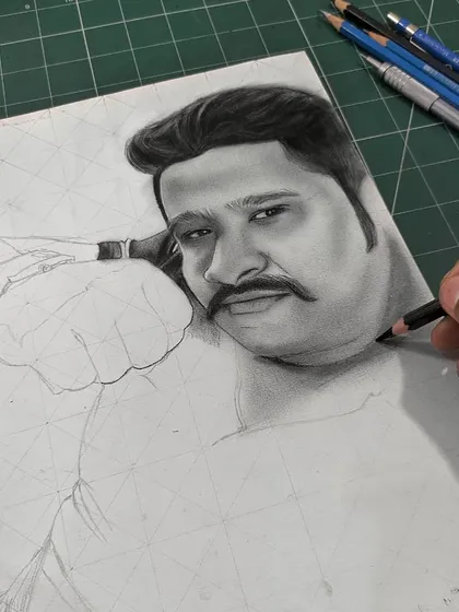 The same commission work, a little further along. I've started to add shading to the face to build up the three-dimensional form, working from light to dark with different grades of pencils.