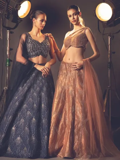 A tale of two styles. This shot features a dramatic navy blue lehenga next to a shimmering gold one, showcasing the versatility of my bridal designs.