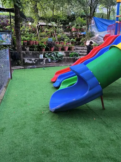 The artificial turf provides a clean edge against the play slides, ensuring no mud or dirt.