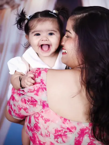 A beautiful, candid moment between a mother and her laughing daughter.