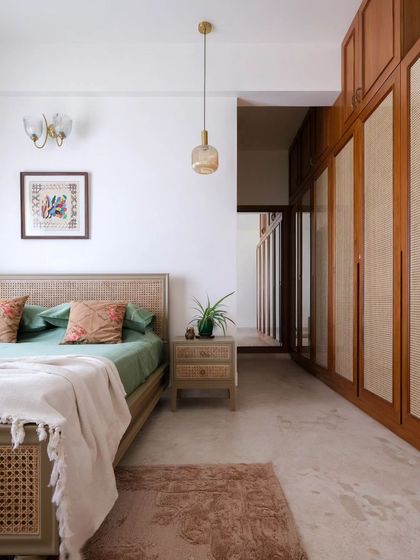Another angle of the master bedroom, showing the rattan wardrobe and the full-length mirror that adds depth to the room as you enter.