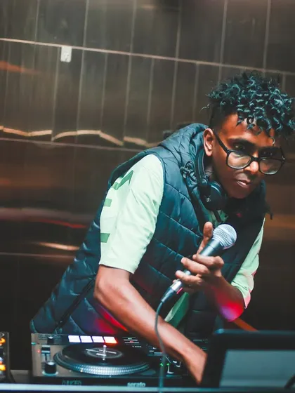 On the mic, connecting directly with the audience. Sometimes you have to guide the energy not just with the music, but with your voice.