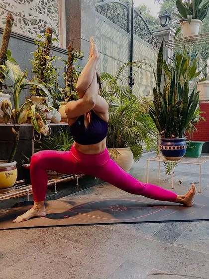 A side lunge, Skandasana, with Garudasana (Eagle) arms. This pose opens the hips and shoulders simultaneously, teaching us to find stillness and focus when the breath wanders.