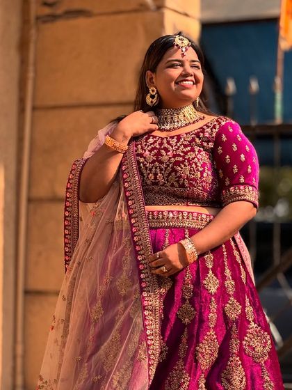 Look at that smile! This bride is glowing in a royal purple velvet lehenga. The detailed embroidery and choker-style neckline create a stunning bridal look.